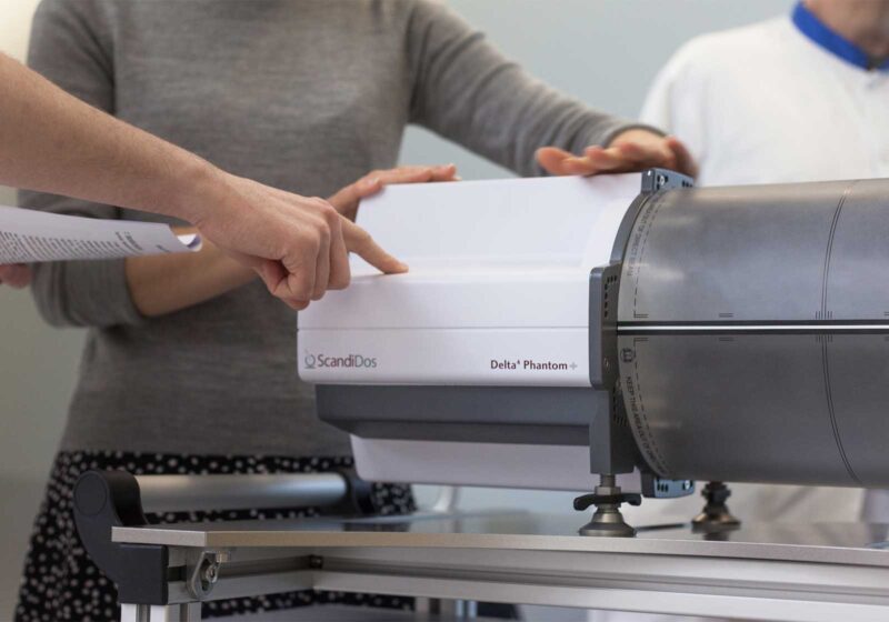 People standing next to Delta4 Phantom+ MR