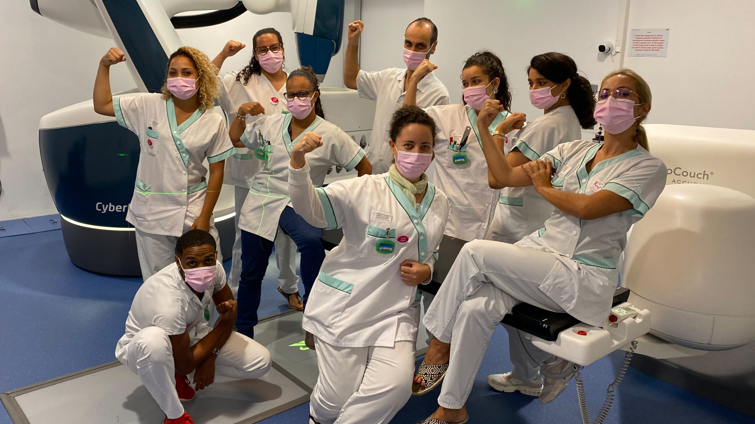 Happy R2 team next to Accuray CyberKnife