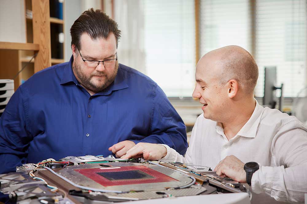 ScandiDos staff looking at QA product